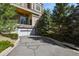 Exterior view of the building and the garage, surrounded by lush green trees at 5677 S Park Pl # 303, Englewood, CO 80111