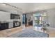 Open-concept living space with modern kitchen, hardwood floors, dining area, and a walk out to the balcony at 5677 S Park Pl # 303, Englewood, CO 80111
