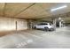 Parking garage featuring a vehicle parked in a numbered spot with storage lockers nearby at 5677 S Park Pl # 303, Englewood, CO 80111