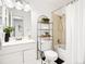 Cozy bathroom features classic fixtures, black and white tile flooring, and stylish shelving at 1980 S Xanadu Way # 208, Aurora, CO 80014