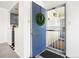 Blue front door with secure screen and welcoming wreath at 1980 S Xanadu Way # 208, Aurora, CO 80014