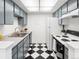 Efficient kitchen featuring black and white tile and appliances at 1980 S Xanadu Way # 208, Aurora, CO 80014