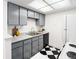 Updated kitchen with gray cabinets and modern appliances at 1980 S Xanadu Way # 208, Aurora, CO 80014