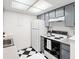 Bright kitchen with sleek appliances and black-and-white tile at 1980 S Xanadu Way # 208, Aurora, CO 80014