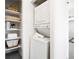 Efficient laundry area with stacked washer and dryer and convenient built-in shelving at 1980 S Xanadu Way # 208, Aurora, CO 80014