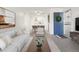 Bright living room flowing into dining area, featuring modern decor at 1980 S Xanadu Way # 208, Aurora, CO 80014