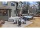 Beautiful backyard featuring a patio with a hot tub and seating, ideal for relaxation and enjoying the outdoors at 31699 Southern Hills Pl, Evergreen, CO 80439