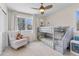 Bright bedroom featuring a bunk bed, neutral walls, carpeted floors, and a large window at 31699 Southern Hills Pl, Evergreen, CO 80439