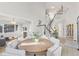 Open-concept dining area with a large round table, staircase, and seamless flow into the living spaces at 31699 Southern Hills Pl, Evergreen, CO 80439