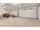 Spacious three car garage with ample room for vehicles, storage, and hobbies with epoxy floor at 31699 Southern Hills Pl, Evergreen, CO 80439