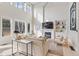 Bright and airy living room with a fireplace, built-in shelving, and large windows offering natural light at 31699 Southern Hills Pl, Evergreen, CO 80439