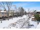 Aerial view shows a community with townhouses and a snowy pathway at 1400 Bacchus Dr # C11, Lafayette, CO 80026