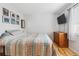 Bedroom with wood floors, a dresser, and patterned bedding at 1400 Bacchus Dr # C11, Lafayette, CO 80026