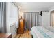 Bedroom with wood floors, dresser, and patterned bedding at 1400 Bacchus Dr # C11, Lafayette, CO 80026