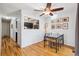 Bright dining area with hardwood floors, ceiling fan, and a view into the kitchen at 1400 Bacchus Dr # C11, Lafayette, CO 80026