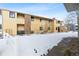 Exterior view of the building showing garages and snow at 1400 Bacchus Dr # C11, Lafayette, CO 80026