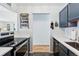 Eat-in kitchen with dark cabinetry, white countertops and access to hallway at 1400 Bacchus Dr # C11, Lafayette, CO 80026