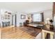 Living room features hardwood floors, a brown couch, and a dining area at 1400 Bacchus Dr # C11, Lafayette, CO 80026