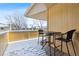 Small patio area with table and chairs, in the snow at 1400 Bacchus Dr # C11, Lafayette, CO 80026