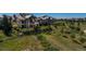 Estate with stone exterior, patios, privacy landscaping, and adjacent community at 10805 Evergold Way, Highlands Ranch, CO 80126