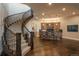 A fully finished basement area with a staircase, wood floors, and a wet bar with cabinet storage at 10805 Evergold Way, Highlands Ranch, CO 80126