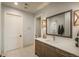 Bathroom with a framed mirror, sleek vanity, and stylish sconces in a well-lit space at 10805 Evergold Way, Highlands Ranch, CO 80126