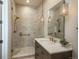 This bathroom has a neutral color palette and a shower with a glass enclosure and bronze fixtures at 10805 Evergold Way, Highlands Ranch, CO 80126