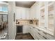 Cozy butler's pantry with custom cabinetry, a wine fridge, and elegant fixtures at 10805 Evergold Way, Highlands Ranch, CO 80126