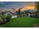 Charming home with well-manicured lawn and ambient outdoor lighting at dusk at 10805 Evergold Way, Highlands Ranch, CO 80126
