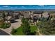 Stunning exterior elevation of a luxury home with lush landscaping and mountain views at 10805 Evergold Way, Highlands Ranch, CO 80126