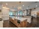 Gourmet kitchen with large island, pendant lighting, and modern appliances at 10805 Evergold Way, Highlands Ranch, CO 80126