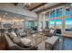 Spacious living room with high ceilings, large windows, and stylish furnishings overlooking mountain views at 10805 Evergold Way, Highlands Ranch, CO 80126