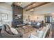 Elegant living room boasts a fireplace, high ceilings, and stylish furniture creating a welcoming and sophisticated atmosphere at 10805 Evergold Way, Highlands Ranch, CO 80126