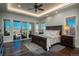 Bright main bedroom with a balcony, hardwood floors, and scenic views at 10805 Evergold Way, Highlands Ranch, CO 80126