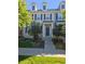 Tan and gray two-story townhome with dark brown shutters and landscaping at 8436 E 35Th Ave, Denver, CO 80238