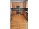 Well-equipped kitchen with wooden cabinetry and hardwood floors at 8436 E 35Th Ave, Denver, CO 80238