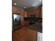 L-shaped kitchen with hardwood floors and stainless steel appliances at 8436 E 35Th Ave, Denver, CO 80238