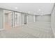 Spacious finished basement with neutral carpet, access to a full bathroom, and multiple doorways at 2122 S Zephyr St, Lakewood, CO 80227
