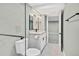 Bright bathroom featuring a vanity, modern fixtures, toilet, and tiled floors at 2122 S Zephyr St, Lakewood, CO 80227