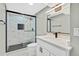 Modern bathroom features tiled shower with glass door, vanity, and updated fixtures at 2122 S Zephyr St, Lakewood, CO 80227
