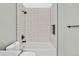 Bathroom showcases modern subway tile, sleek fixtures, and a built-in shower niche for added convenience at 2122 S Zephyr St, Lakewood, CO 80227
