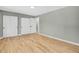 Spacious bedroom with hardwood floors, neutral gray walls, and double closets offering ample storage at 2122 S Zephyr St, Lakewood, CO 80227