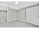 Clean bedroom with neutral walls, plush carpeting, and a double door closet at 2122 S Zephyr St, Lakewood, CO 80227