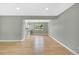 Open dining room with hardwood floors and neutral walls leads to a modernized kitchen at 2122 S Zephyr St, Lakewood, CO 80227