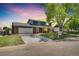 Charming two-story home with brick accents, covered porch, and well-manicured front lawn at 2122 S Zephyr St, Lakewood, CO 80227