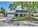 Charming two-story home with brick accents, covered porch, and well-manicured front lawn at 2122 S Zephyr St, Lakewood, CO 80227