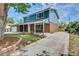 Charming home with brick and siding exterior, covered porch, and mature tree at 2122 S Zephyr St, Lakewood, CO 80227