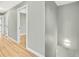 Hallway with light gray walls, wood floors and white trim at 2122 S Zephyr St, Lakewood, CO 80227