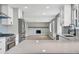 Bright kitchen with stainless steel appliances, white cabinets, and an open view to living room at 2122 S Zephyr St, Lakewood, CO 80227