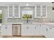 Modern kitchen features white cabinetry, gray backsplash, stainless steel appliances, and ample lighting at 2122 S Zephyr St, Lakewood, CO 80227